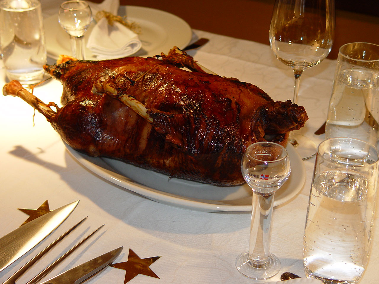 Photo of a roast goose on table.